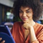 Portrait of beautiful African businesswoman at work. Image is being used for a blog post titled, "Revenue Refresh: Newswire Offers Cutting-Edge PR and Media Strategies for CROs"