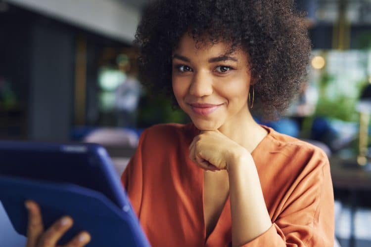 Portrait of beautiful African businesswoman at work. Image is being used for a blog post titled, "Revenue Refresh: Newswire Offers Cutting-Edge PR and Media Strategies for CROs"