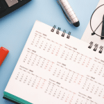 Picture of a calendar, pens, and keyboard for a blog post about holiday content creation.