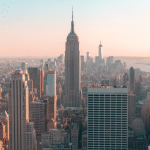 Picture of the Empire State building and part of the New York skyline. Image is being used for a Newswire blog post about the top media outlets in New York.