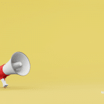 Picture of a white and red megaphone on a yellow background. Image is being used for a Newswire blog about three press release promotion ideas.