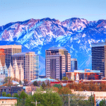 Picture of the Salt Lake City, Utah skyline with a mountain range in the backdrop. Image is being used for a Newswire blog post about the top media outlets in Utah.